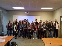 Incoming Freshman class members receiving scarves after completing their Freshman Seminar