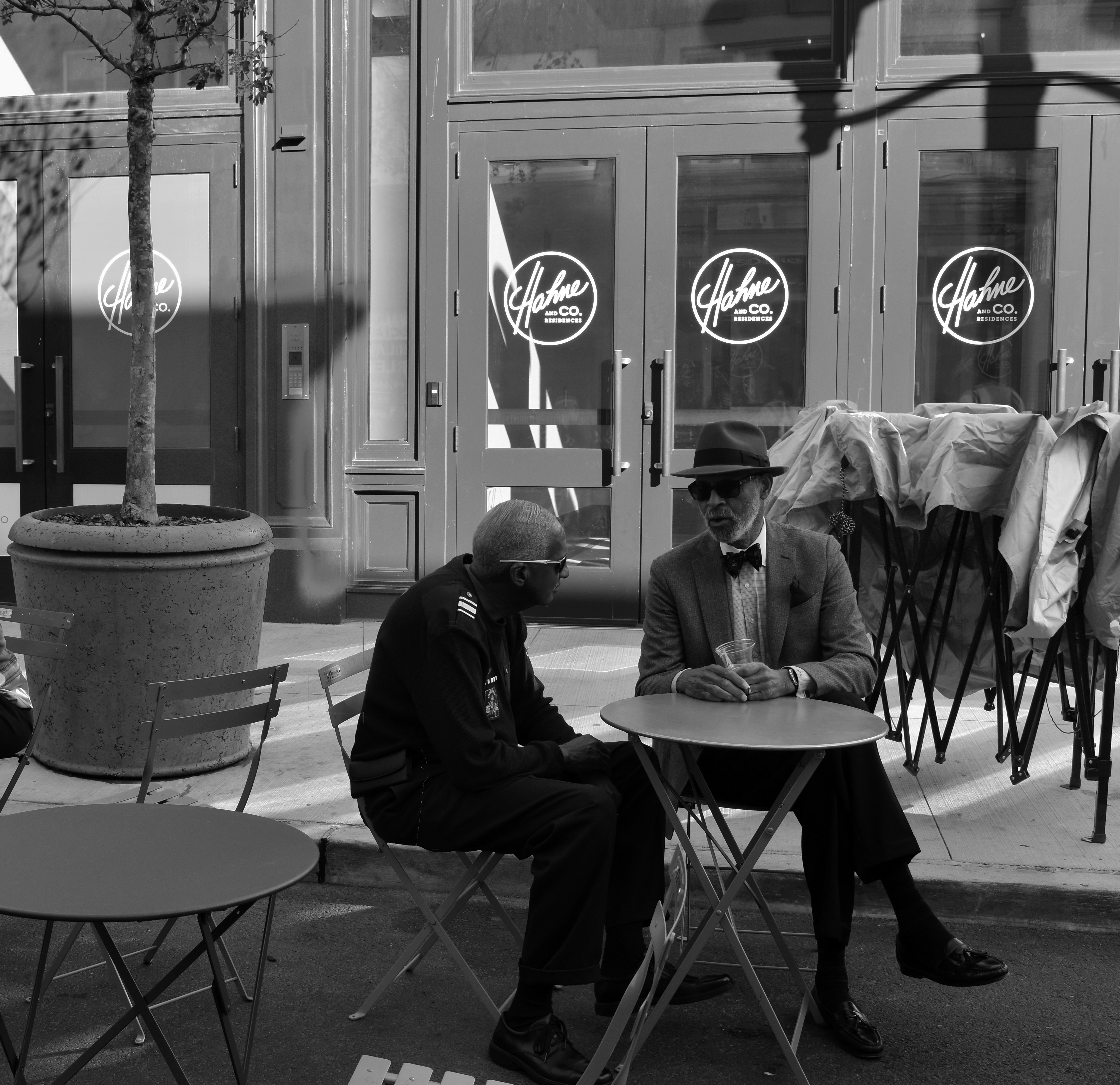 Winning photo by Shanee Halevi (two men sitting at a table outside of the renovated Hahne&#039;s Building in Newark)